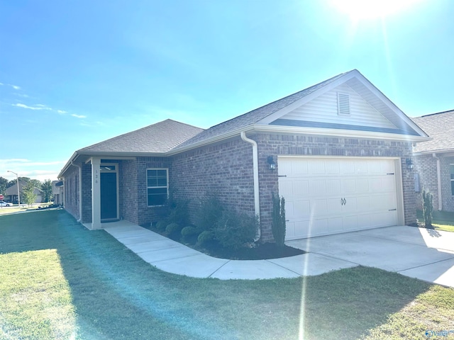 ranch-style home with a garage and a front lawn