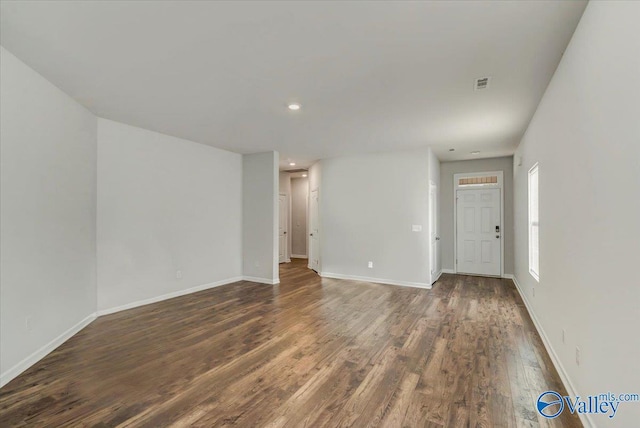 unfurnished room with recessed lighting, wood finished floors, visible vents, and baseboards