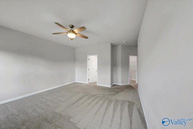 unfurnished room with ceiling fan, baseboards, and carpet flooring