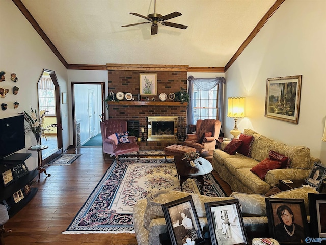 living room featuring ornamental molding, a brick fireplace, hardwood / wood-style flooring, and a healthy amount of sunlight