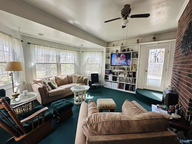 carpeted living room featuring brick wall, a wealth of natural light, and a ceiling fan