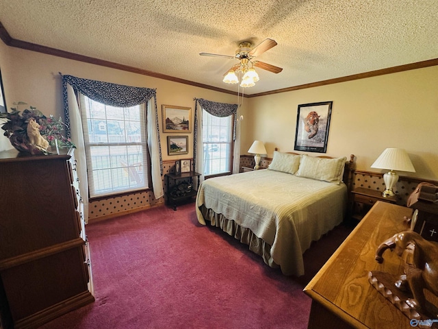 bedroom with ceiling fan, a textured ceiling, dark carpet, and crown molding