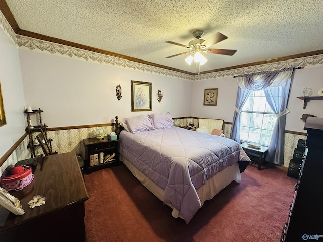 bedroom featuring dark carpet, ornamental molding, a textured ceiling, and wainscoting