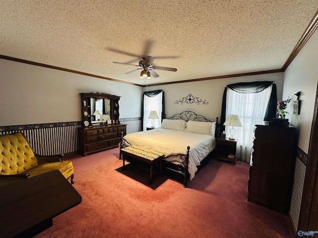 bedroom with a textured ceiling, carpet floors, ornamental molding, and ceiling fan