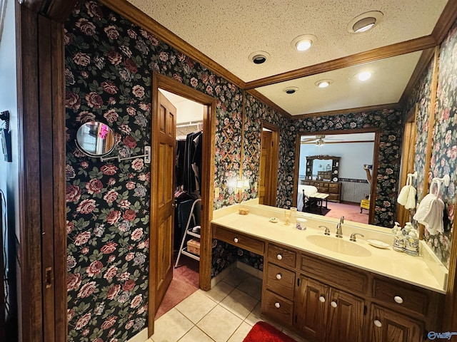 bathroom with ornamental molding, vanity, a textured ceiling, tile patterned flooring, and wallpapered walls