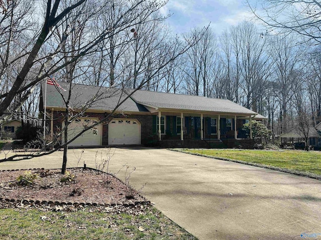 ranch-style home with driveway, a front lawn, and an attached garage