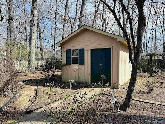 view of outbuilding featuring an outdoor structure and fence