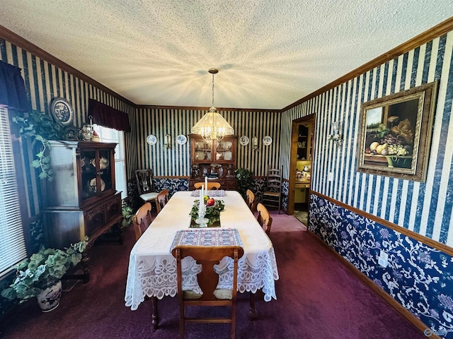 carpeted dining area with crown molding, a textured ceiling, an inviting chandelier, and wallpapered walls