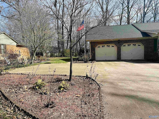 view of yard with driveway and an attached garage