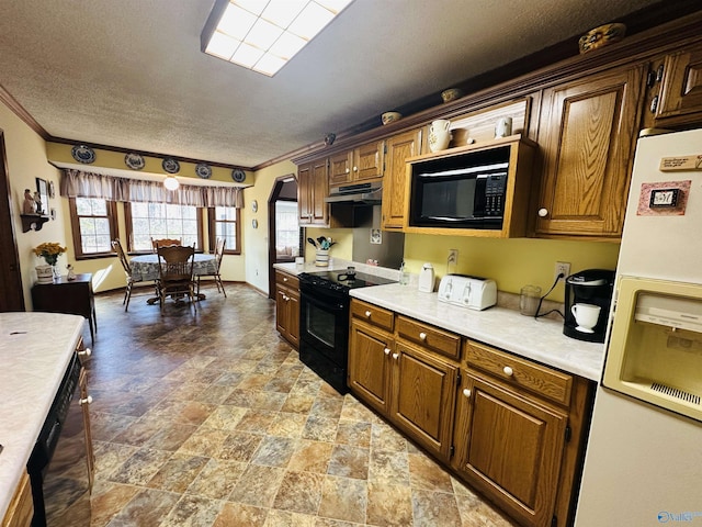 kitchen featuring black appliances, ornamental molding, light countertops, and under cabinet range hood