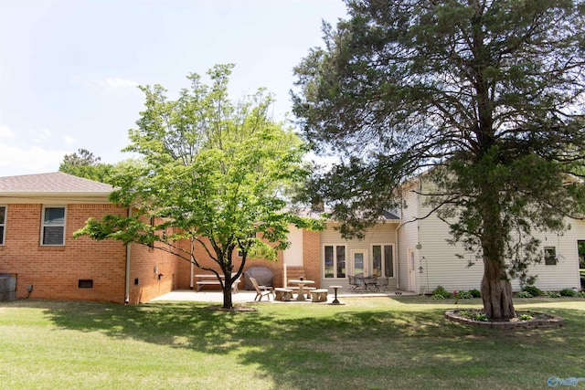 rear view of house featuring a yard and a patio area