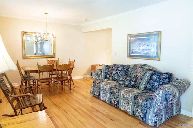 living room with ornamental molding, wood-type flooring, and an inviting chandelier