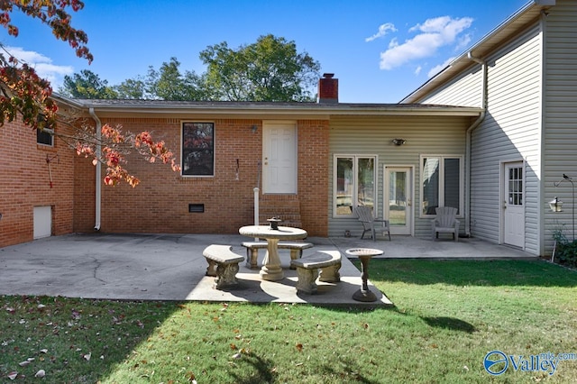 rear view of property featuring a yard and a patio