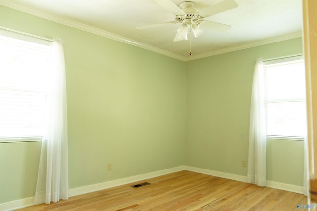 empty room featuring ornamental molding, light hardwood / wood-style floors, and ceiling fan