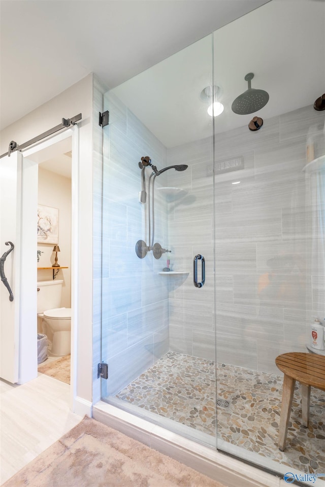full bath featuring toilet and a stall shower