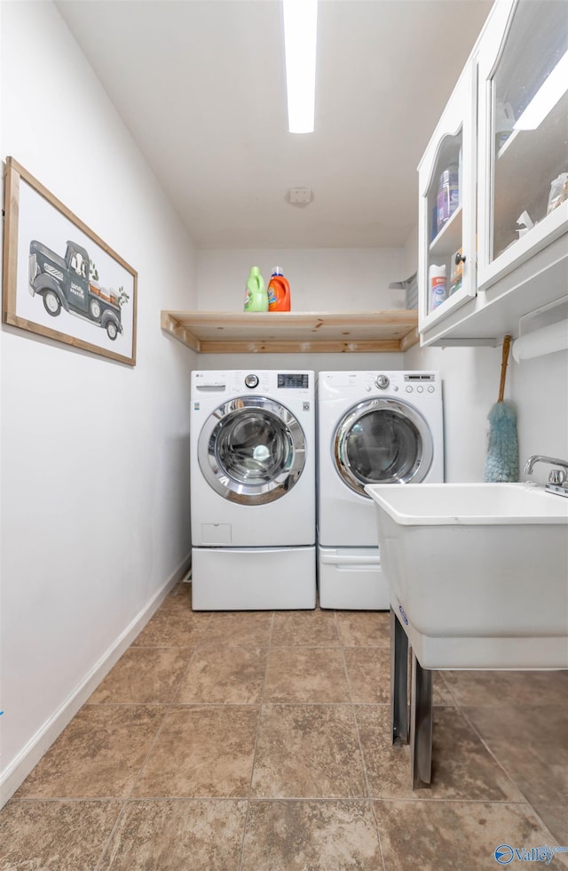 clothes washing area featuring washer and dryer, baseboards, and laundry area