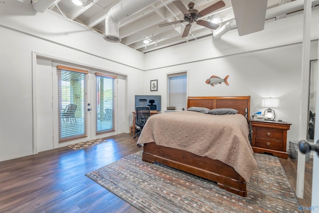 bedroom with french doors, access to exterior, a ceiling fan, wood finished floors, and a high ceiling