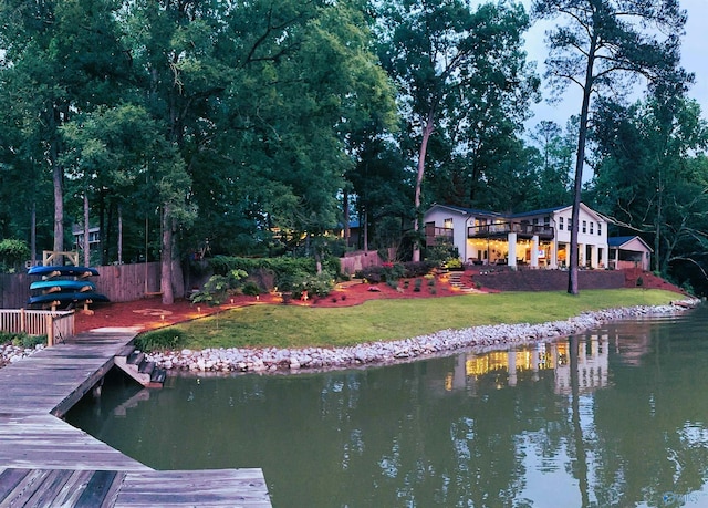 exterior space featuring a lawn and a water view