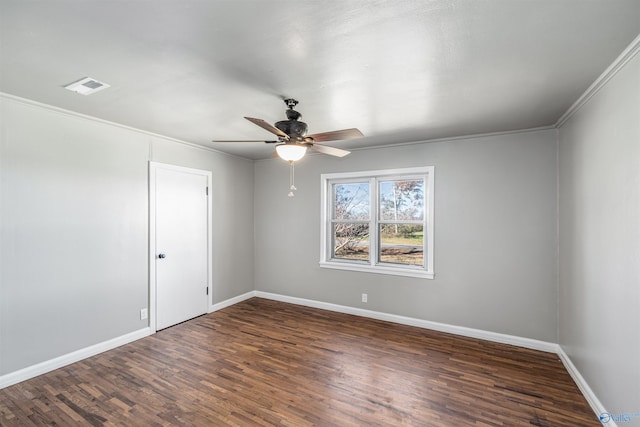 empty room with dark hardwood / wood-style flooring, ceiling fan, and crown molding