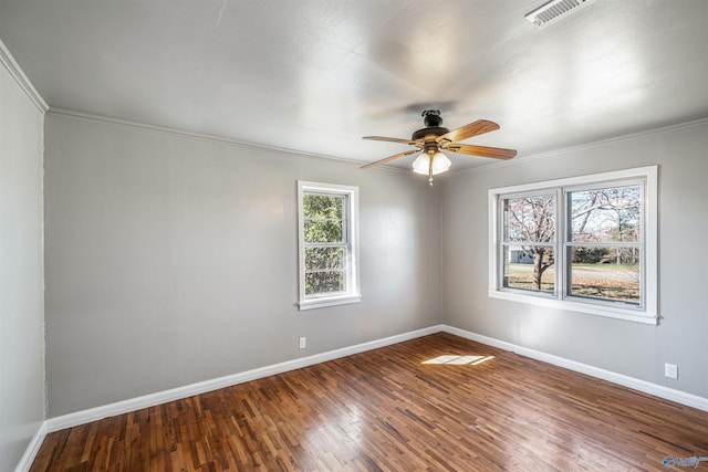 spare room featuring ceiling fan, hardwood / wood-style floors, and crown molding