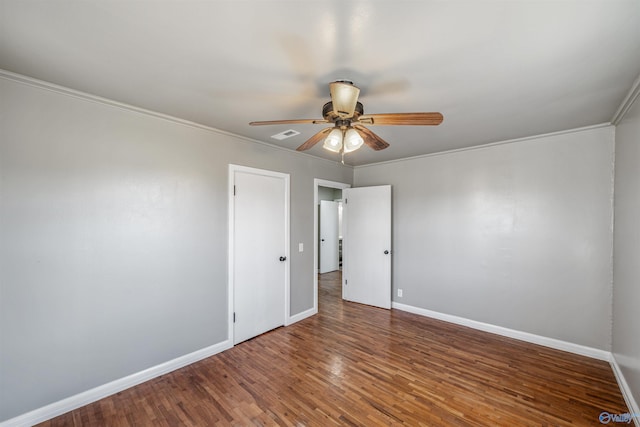 spare room with ceiling fan, wood-type flooring, and ornamental molding