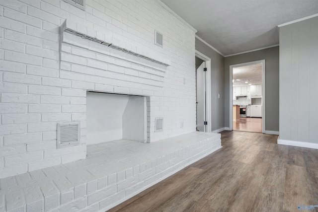 unfurnished living room featuring a textured ceiling, a fireplace, wood-type flooring, and crown molding