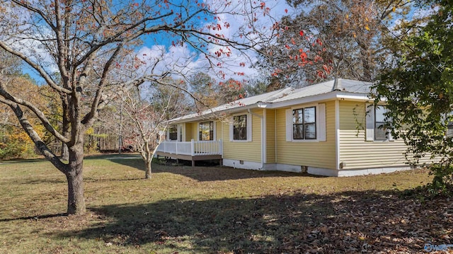 view of side of property with a yard