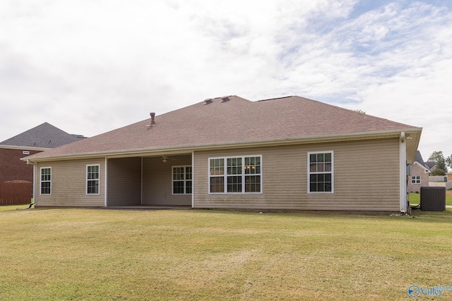 back of house with a yard and central air condition unit