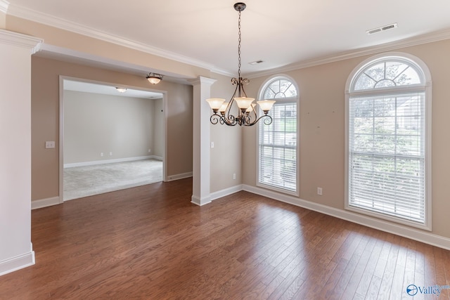 empty room featuring ornamental molding, a chandelier, and dark hardwood / wood-style flooring