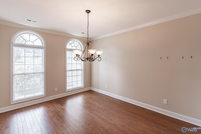 unfurnished room featuring ornamental molding, an inviting chandelier, and dark wood-type flooring