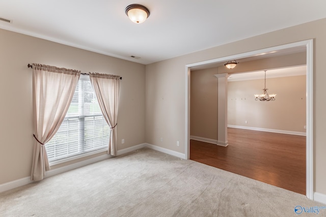 empty room featuring a notable chandelier and hardwood / wood-style flooring