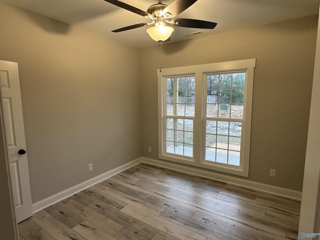 unfurnished room featuring light wood-type flooring and ceiling fan