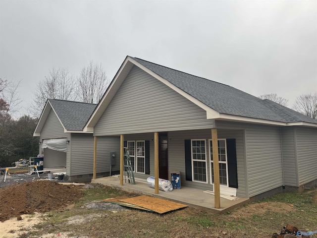 back of house featuring a porch