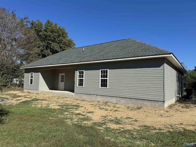 back of property with a patio area and a yard