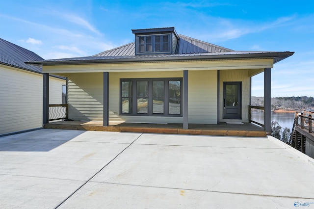 rear view of property featuring a porch and a water view