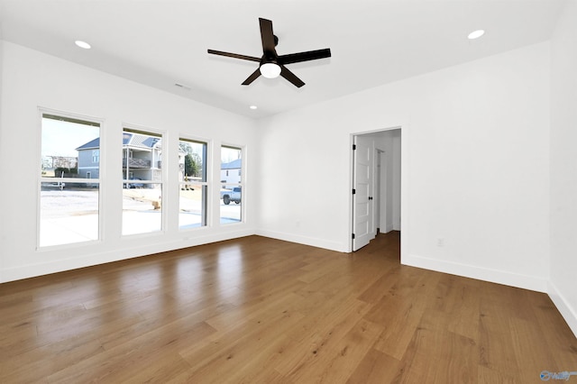 empty room with hardwood / wood-style flooring and ceiling fan