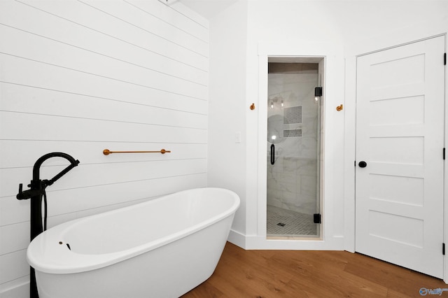 bathroom with wood-type flooring and separate shower and tub