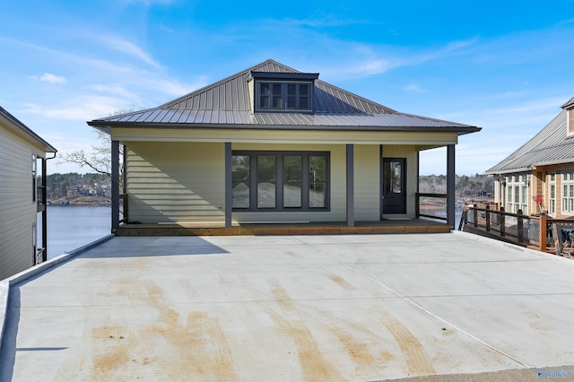 back of house with a porch and a water view