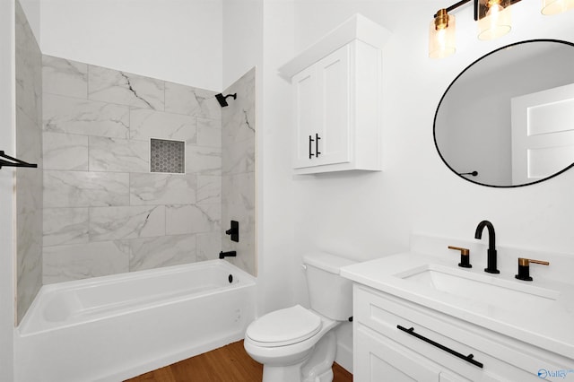 full bathroom featuring vanity, hardwood / wood-style flooring, toilet, and tiled shower / bath