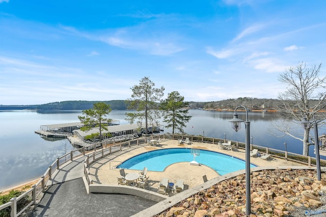 view of swimming pool with a water view