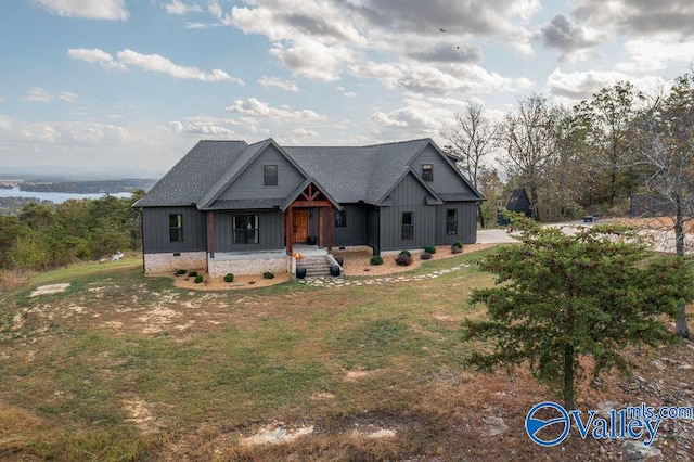 modern farmhouse with a front yard and a water view