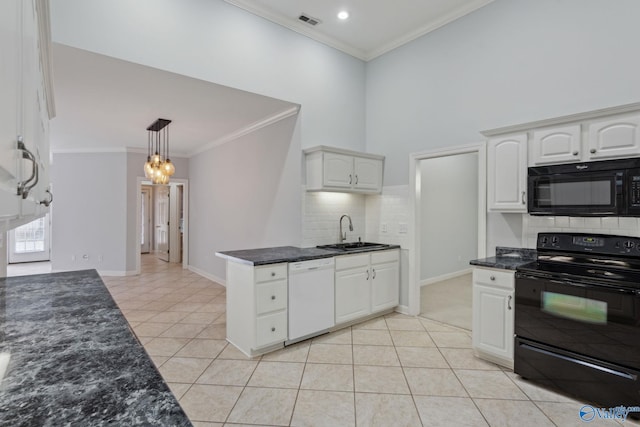 kitchen with sink, light tile patterned floors, decorative light fixtures, white cabinets, and black appliances