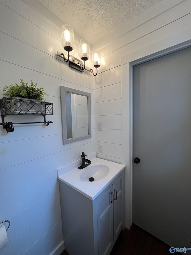 bathroom with a textured ceiling and vanity