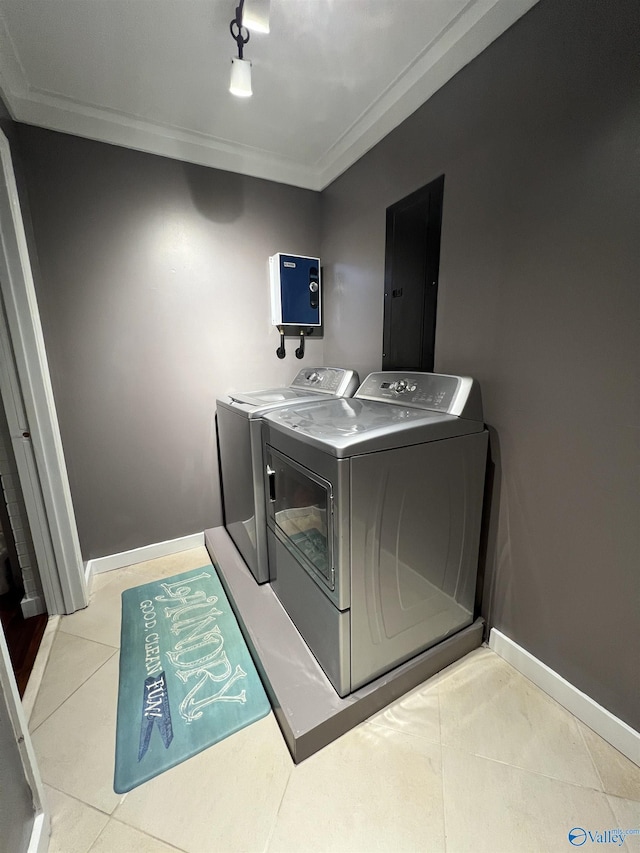 laundry area featuring light tile patterned flooring, laundry area, electric panel, independent washer and dryer, and baseboards