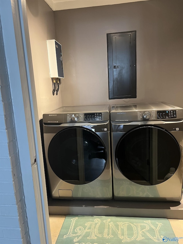 laundry area with laundry area, electric panel, and washer and dryer