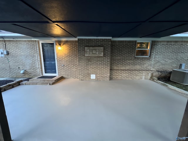 view of patio with central air condition unit and a carport