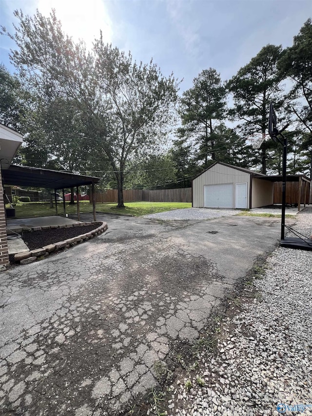 view of yard featuring a garage, an outdoor structure, and fence