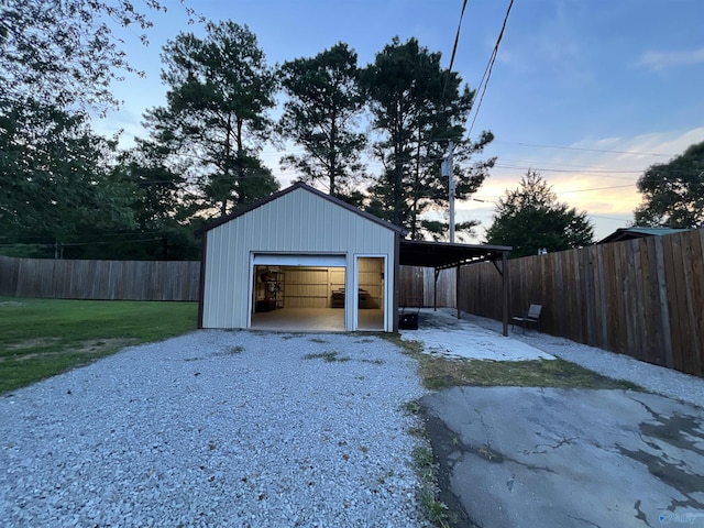 garage with driveway, a garage, and fence