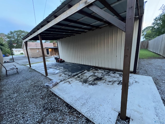 view of patio / terrace featuring fence and a carport