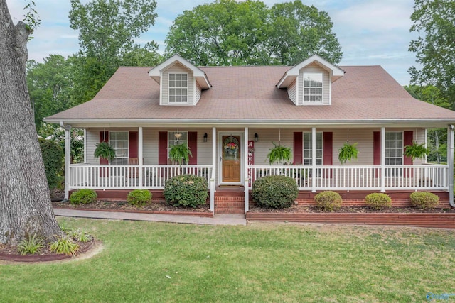 cape cod home featuring a front yard and a porch